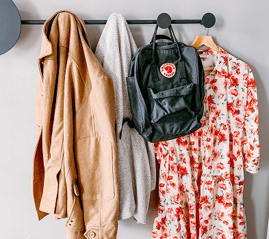 Coat rack with clothes and backpack