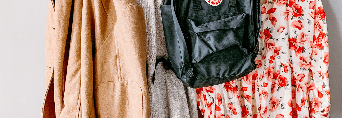 Coat rack with clothes and backpack